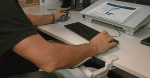 An ergonomic wrist support supports Paul's left hand.