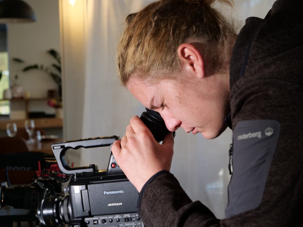 EPIC participant Jala-Loka looking down the viewfinder of his camera