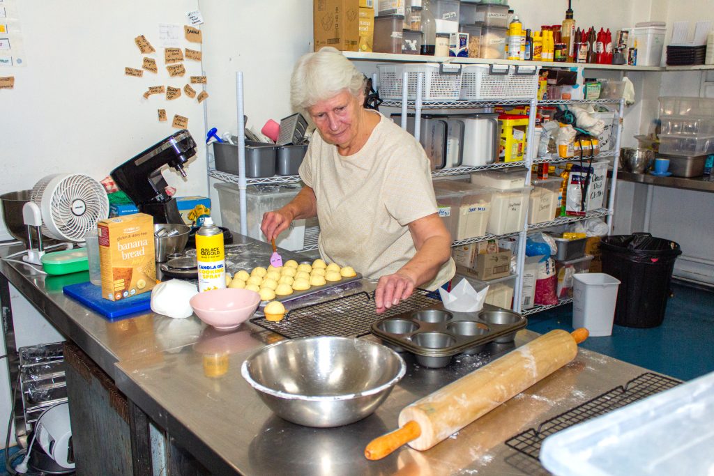 Gwenda hard at work. moving over to ice her famous muffins.