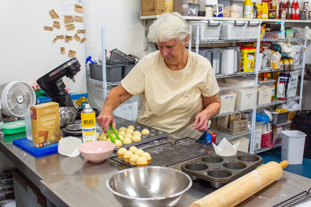 Gwenda working on decorating some delicious muffins.