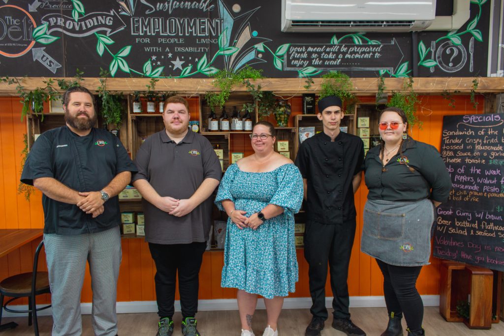 Gabrielle standing with her Deli Cafe team out front.