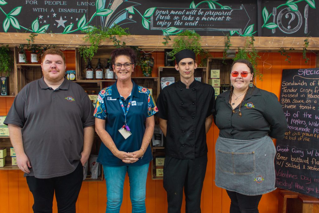 Nathan standing with the rest of his Deli Cafe team and his Employment Consultant Mandy-Lee