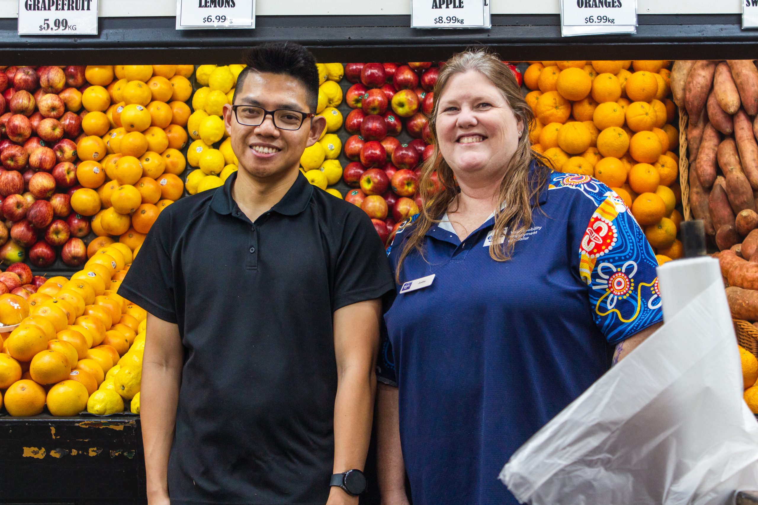 Justin standing in front of the produce with his EC Jodi