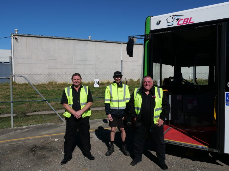 Rob, David, and Travis stood with one of the reliable CBL buses.