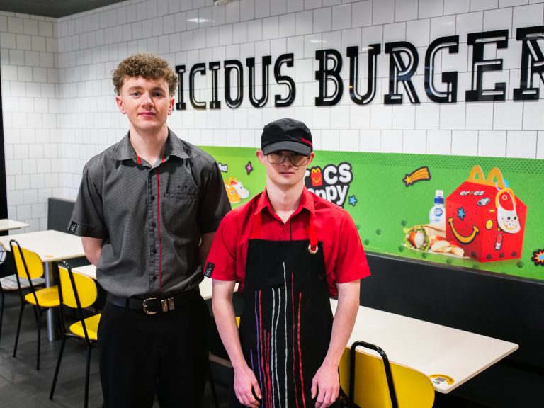 Harry stood in the McDonalds dining room beside his smiling shift manager.